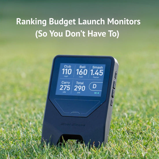 Golfer using a budget launch monitor in an indoor golf simulator setup.