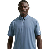 Man wearing a blue patterned polo shirt with a Nike logo on a light gray background