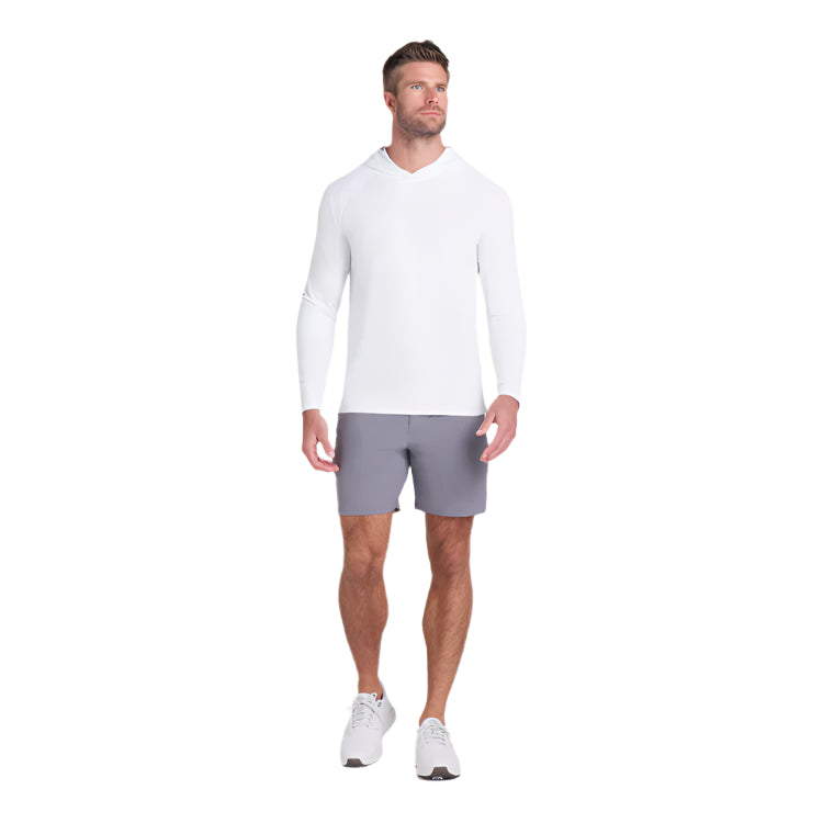 Man wearing a white long-sleeve shirt and gray shorts on a light gray background